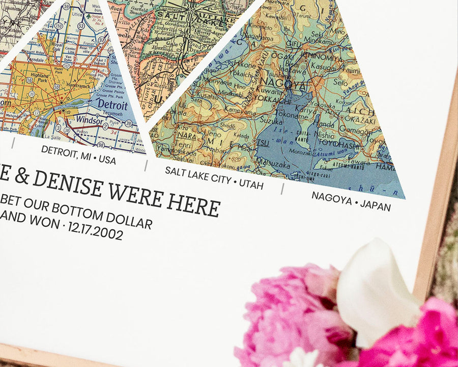 close up personalized adventure map print with 4 triangular vintage map sections each a different location in golden frame.