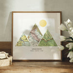 Mountain shaped relief with insert maps. Some flowers in a wood frame