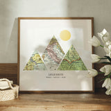 Mountain shaped relief with insert maps. Some flowers in a wood frame