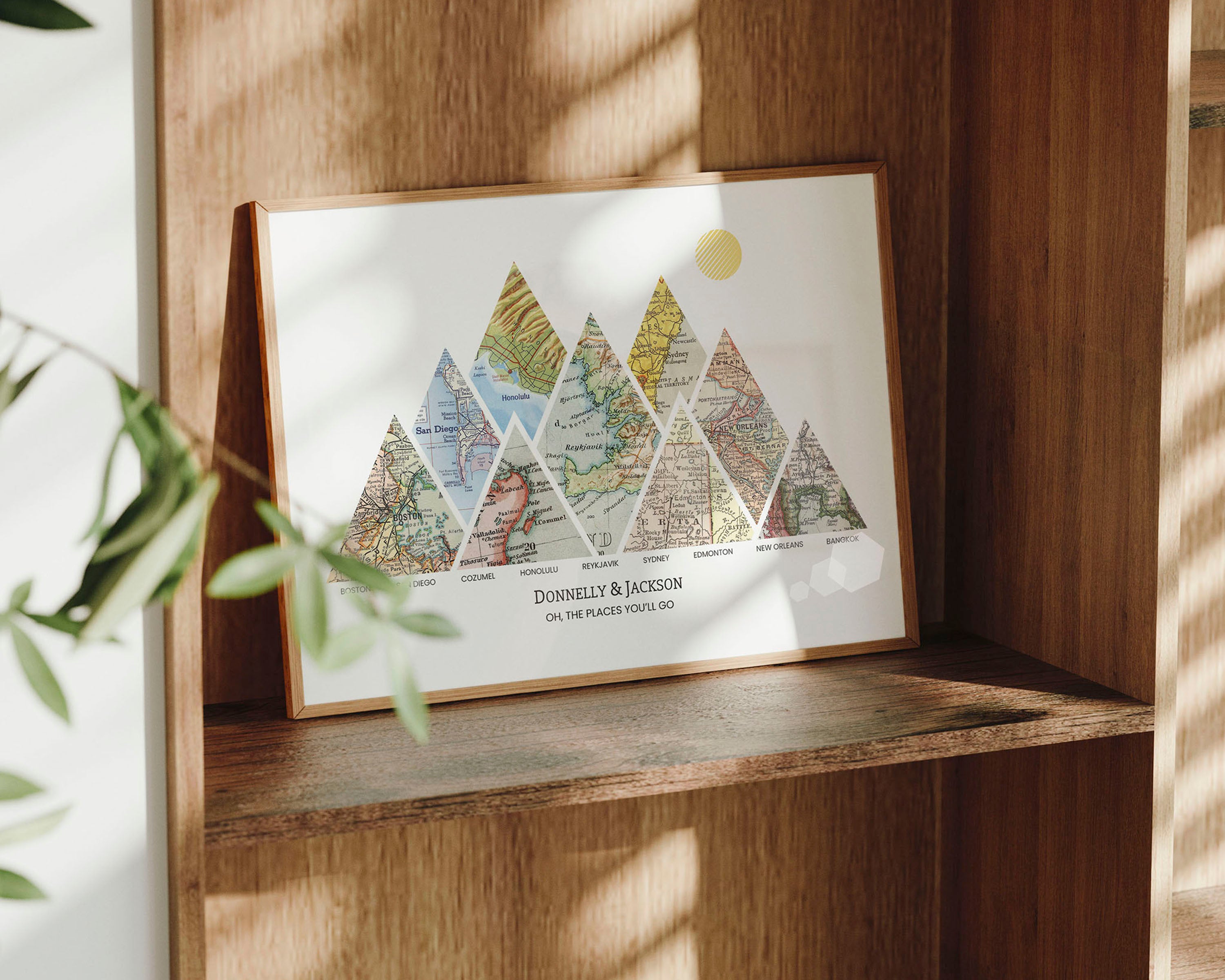 Mountain shaped relief with insert maps wood frame on a shelf.