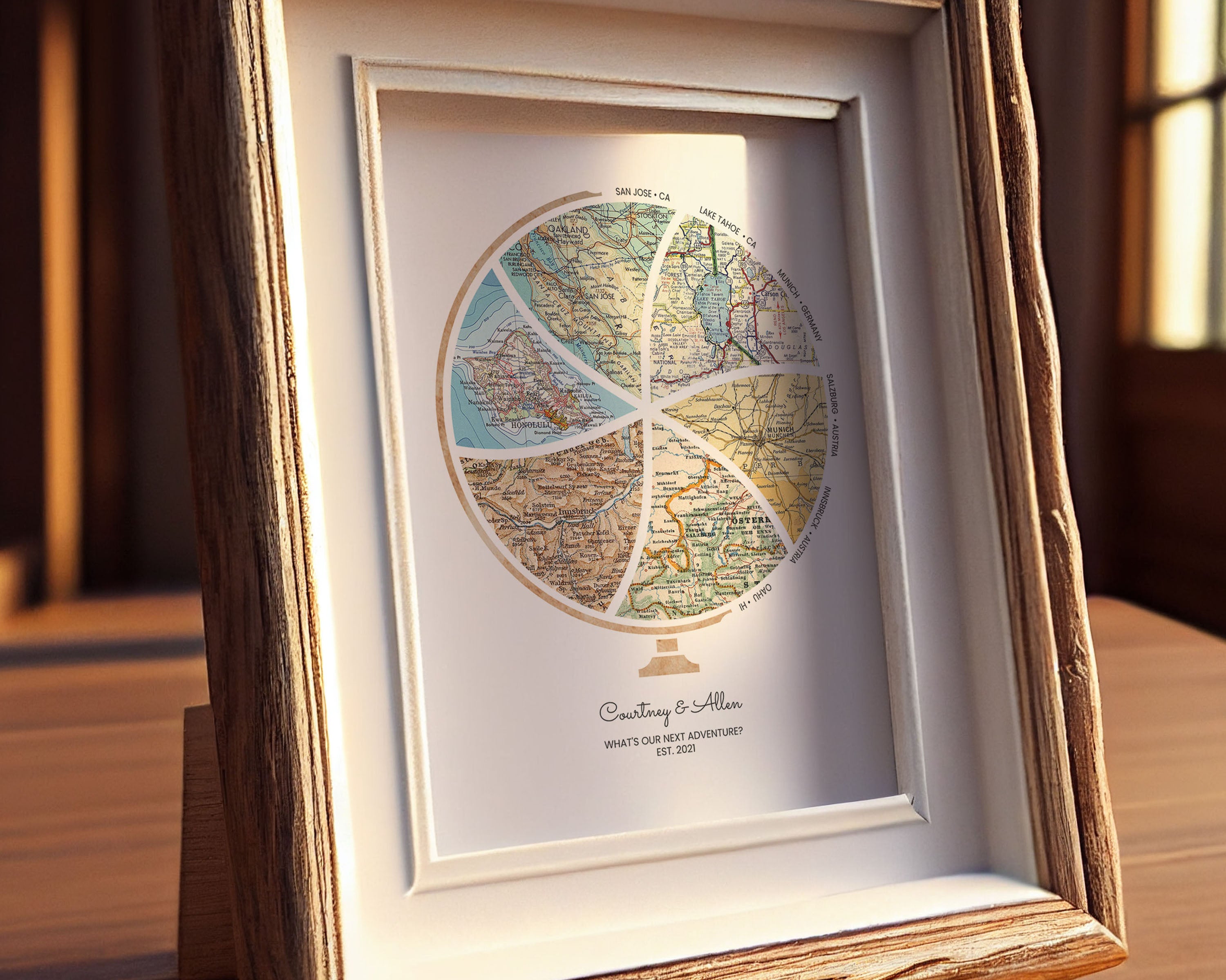 Globe and stand relief design with inset maps. Custom frame on table.