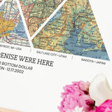 close up personalized adventure map print with 4 triangular vintage map sections each a different location in golden frame.