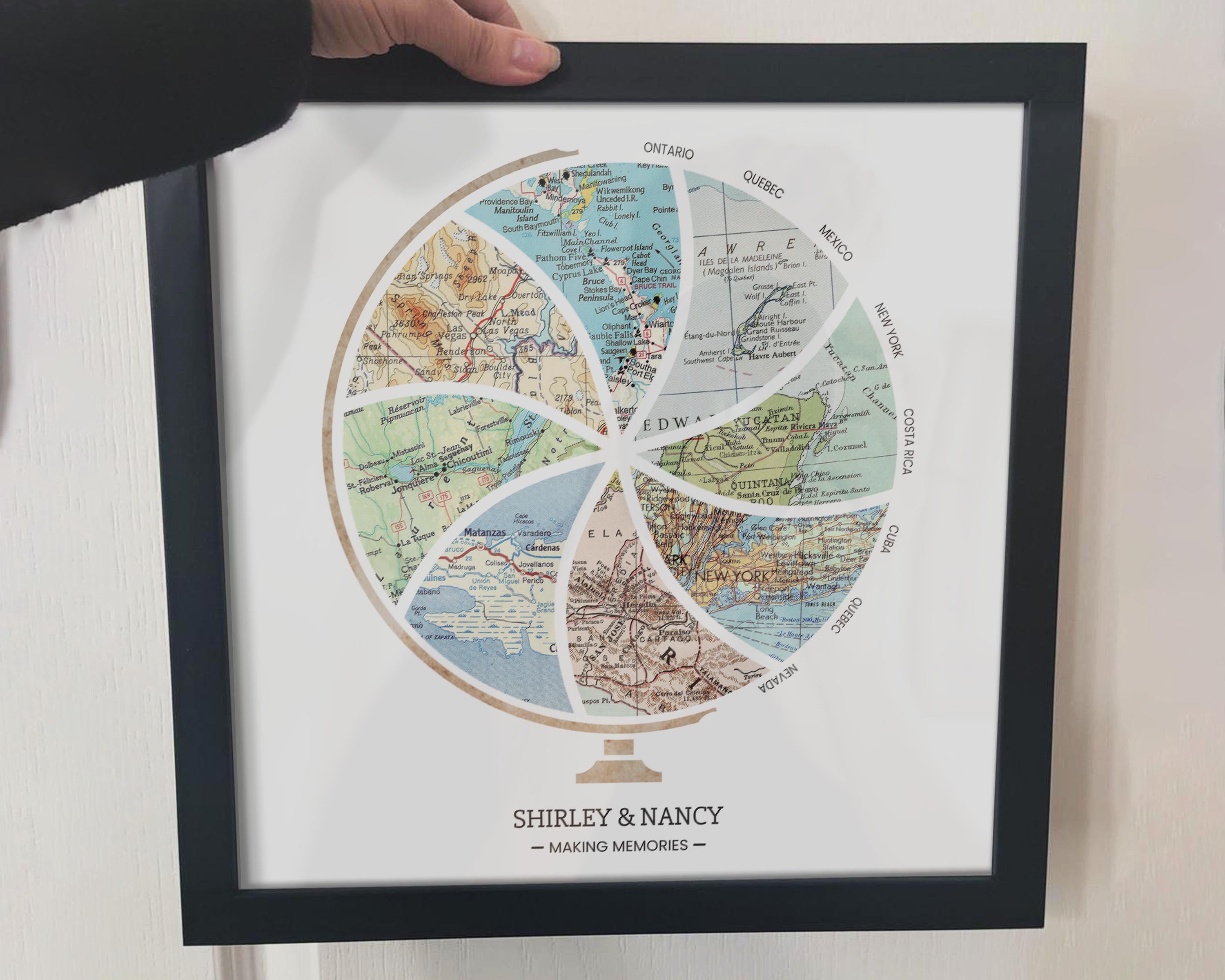 [Black Frame|12x12|8 Maps] Globe and stand relief design with inset maps. Arm holding frame.