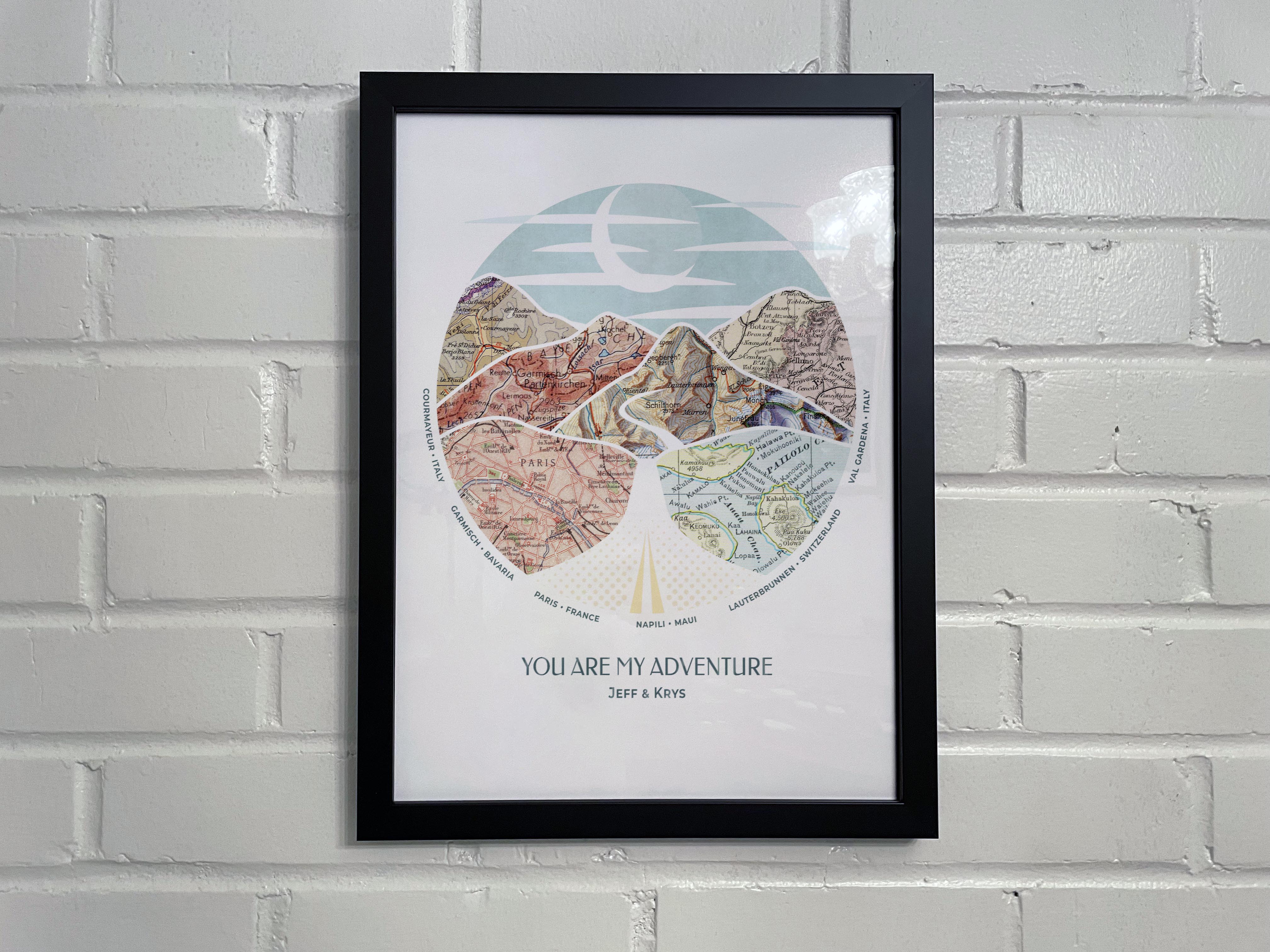 [Black Frame|12x16|6 Maps] Relief of hills and highway into the horizon, with inset maps. On white brick wall