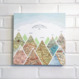 [Canvas Wrap|12x12|8 Maps] Mountain scape relief with inset maps and geometric clouds above.