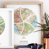 Terra Carta™ Map Print with five maps, leaning against a wall with other art, and an aloe plant in a copper planter