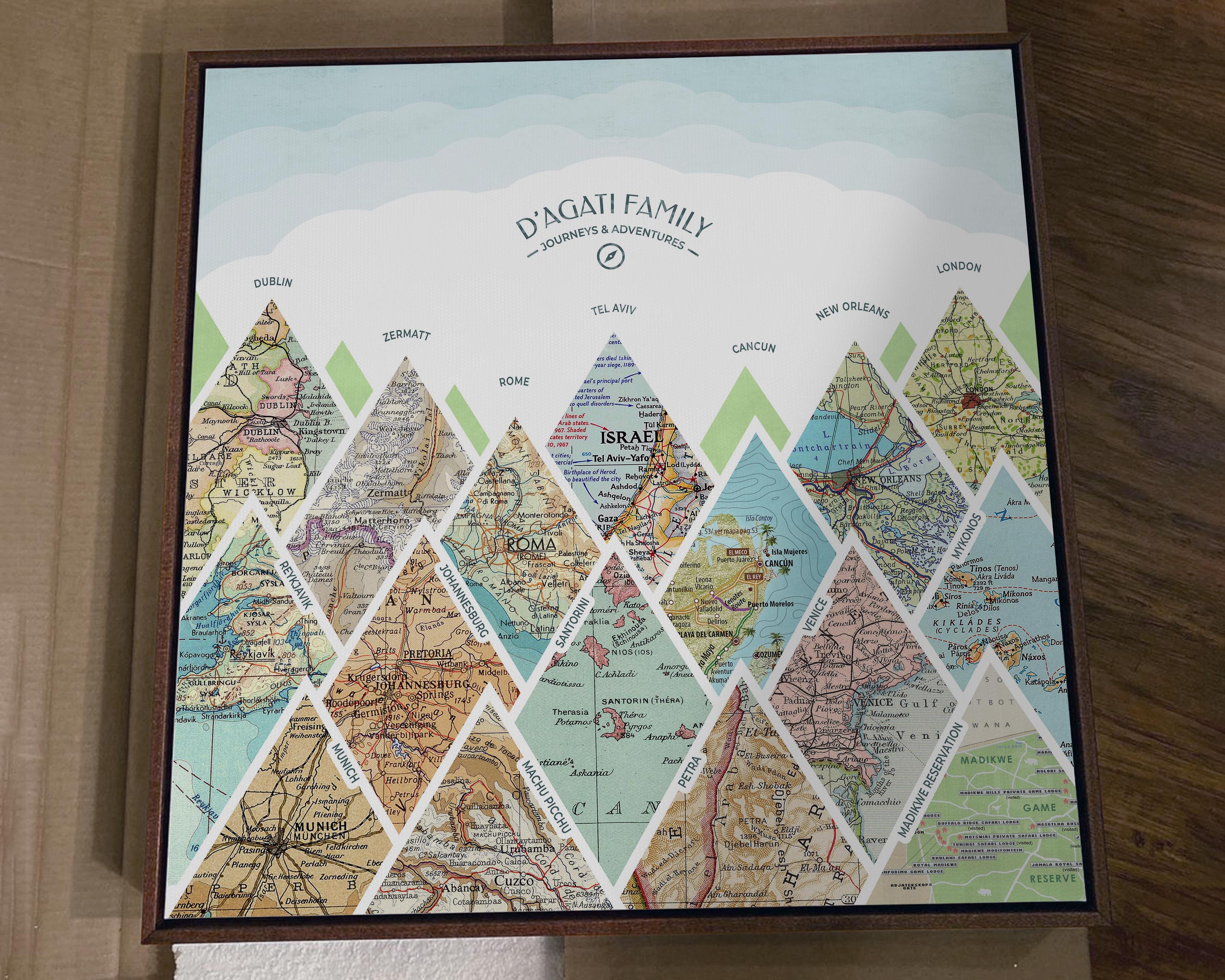 [Walnut Canvas|24x24|15 Maps] Mountain scape relief with inset maps and geometric clouds above.