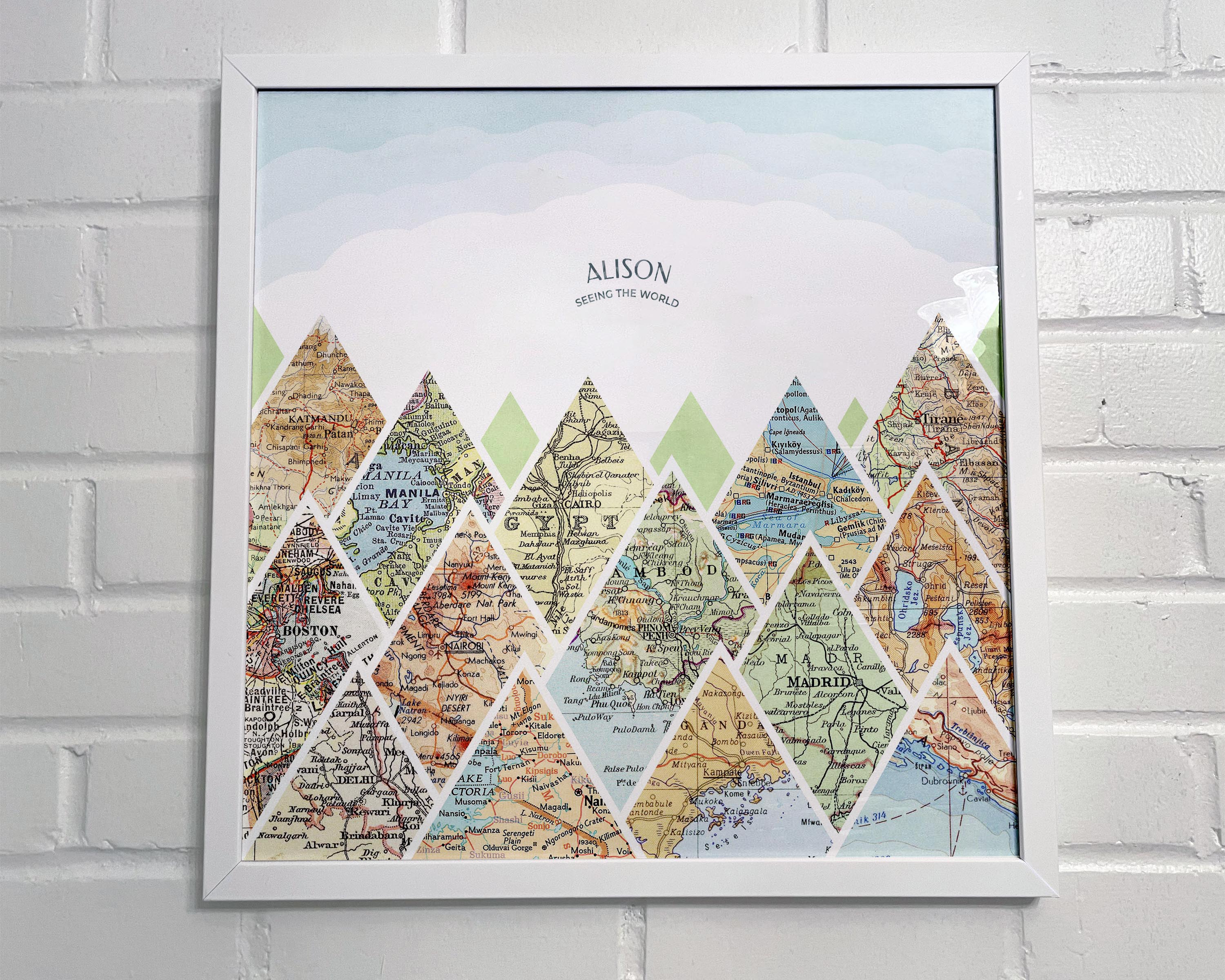 [White Frame|18x18|14 Maps] Mountain scape relief with inset maps and geometric clouds above.