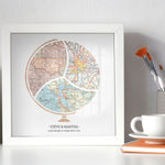 Terra Carta™ Map Print with three maps, sitting on a desk next to a vase, cup full of paint brushes, and a teacup resting on a notebook
