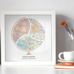 Terra Carta™ Map Print with three maps, sitting on a desk next to a vase, cup full of paint brushes, and a teacup resting on a notebook