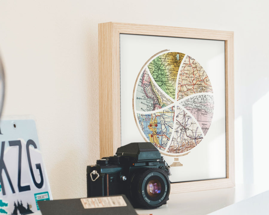 Terra Carta™ Map Print with six maps, sitting on a mantle next to a vintage camera